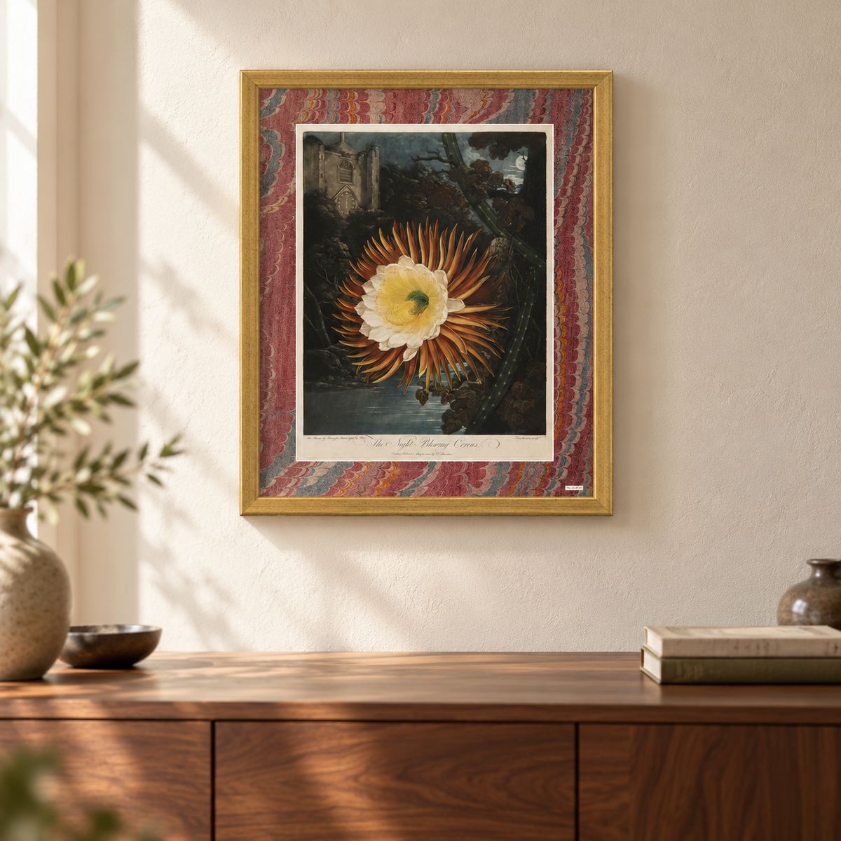 The framed Cereus edition on the wall above a walnut sideboard